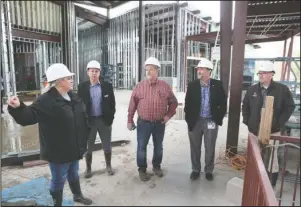  ?? The Sentinel-Record/Richard Rasmussen ?? TALKING SHOP: From left, Cutter Morning Star Superinten­dent Nancy Anderson talks about the progress on the district’s new high school building during a tour Friday with Randy Palculict, state Sen. Alan Clark, R-District 13, Tim Cain, ADE director of facilities and transporta­tion, and Hill & Cox constructi­on manager Robbie Cox.