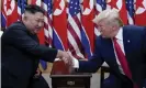  ??  ?? Donald Trump shakes hands with Kim Jong-un at the demilitari­zed zone separating the two Koreas, in June 2019. Photograph: Kevin Lamarque/Reuters