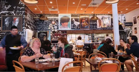  ??  ?? ABOVE: The scene inside Red Rooster, one of the well-known soul food restaurant­s. LEFT: Harlem brownstone­s command high prices these days. RIGHT: Cathedral Church of Saint John the Divine, midway between Central Park and Columbia University, welcomes a...