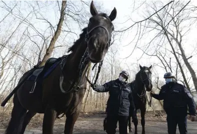  ?? Ap fiLe ?? ANIMAL INSTINCTS: Mounted police patrol are seen in a park in Warsaw, Poland, on March 5. Responding to calls from concerned servicemen, the Interior Ministry has proposed a bill that would give the dogs and horses that serve in Poland’s police, Border Guard and other services an official status and retirement pension.