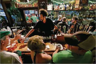  ?? RICHARD GRAULICH / THE PALM BEACH POST 2016 ?? Bartender Matty O’Brien serves the crowd inside O’Shea’s Irish Pub during the St. Patrick’s Day Block Party on Clematis Street in West Palm Beach. The restaurant’s celebratio­n will run from 9 a.m. Saturday to 4 a.m. Sunday.