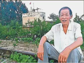  ??  ?? Cao sitting on railway tracks in front of a watchtower built by Japanese troops in Cangxian county, Hebei province. — China Daily/Asia News Network Historical site: