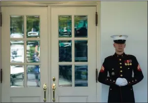  ?? The Associated Press ?? OVAL OFFICE: A Marine is posted outside the West Wing of the White House, signifying the President is in the Oval Office, Wednesday in Washington. President Donald Trump on Wednesday credited an experiment­al drug treatment with helping his recovery from COVID-19 and suggested his diagnosis could be a “blessing in disguise” in the nation’s battle against the pandemic. But there is no way for the president or his doctors to know whether the drug had any effect.