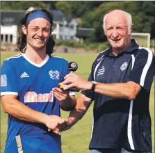  ?? Photograph: Kevin McGlynn. ?? Andrew King of Kyles Athletic receives the man of the match award from David Thomson on behalf of the Macaulay Associatio­n after the Macaulay Cup semi final at Mossfield.