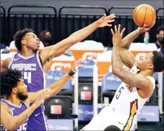  ?? (AP) ?? New Orleans Pelicans guard Eric Bledsoe, right, shoots against Sacramento Kings’ Marvin Bagley III, left, and Buddy Hield, center, during the first quarter of an NBA basketball game in Sacramento, Calif, on Jan 17.