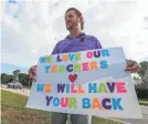  ??  ?? Ian Kravitz, 47, greets teachers Monday as they return to Marjory Stoneman Douglas High School in Parkland, Fla. ANDREA MELENDEZ/ USA TODAY NETWORK