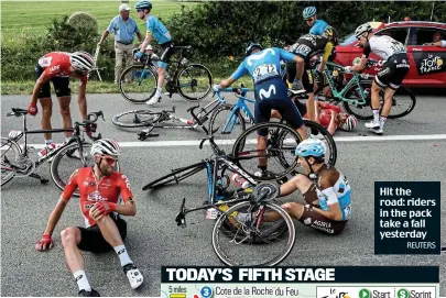  ?? REUTERS ?? Hit the road: riders in the pack take a fall yesterday