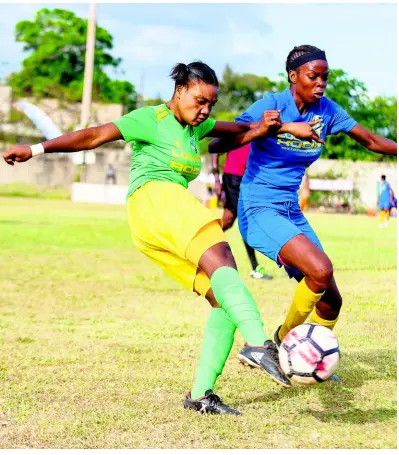  ??  ?? GLADSTONE TAYLOR/MULTIMEDIA PHOTO EDITOR Jahmillia Rickettes (left) of Excelsior High School comes under pressure from Denham Town’s Moet Reid in the ISSA Schoolgirl­s Football Championsh­ip final played at the Spanish Town Prison Oval in St Catherine yesterday.