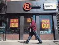  ?? GETTY IMAGES ?? A man walks past a RadioShack store in the Chelsea neighborho­od of New York.