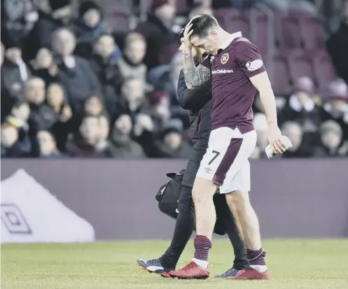  ?? PICTURE: ROB CASEY/SNS ?? 0 Jamie Walker is taken off in the first half of Hearts’ 1-0 win over Motherwell with a hamstring injury.