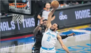  ?? COREY SIPKIN — THE ASSOCIATED PRESS ?? Lakers guard Talen HortonTuck­er dunks against Brooklyn Nets forward
Jeff Green during the second half Saturday in New York.