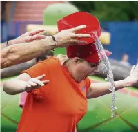  ??  ?? above: Clockwise from Crowds enjoy watching the games Olivia Doherty, 7, from Stockport, enjoys her candy floss Saul Walton, 5, from Cheadle Heath with his happy face on A contestant gets a soaking Twins Samantha and Sophia Aird, 4 and from Cheadle...