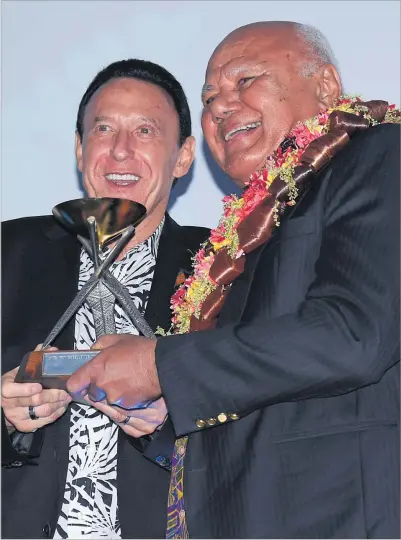 ?? Picture: REINAL CHAND ?? Fiji Airways managing director and chief executive officer Andre Viljoen, left, receives the Visionary Award from Deputy Prime Minister and Minister for Tourism and Civil Aviation, Viliame Gavoka during the ANZ Fiji Excellence in Tourism Awards at the Sheraton Fiji Golf and Beach Resort on Denarau, Nadi.