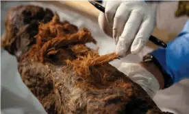  ?? Geographic/Windfall Films Photograph: Ian Glatt/National ?? A scientist examines the Khuwy mummy, discovered in 2019.