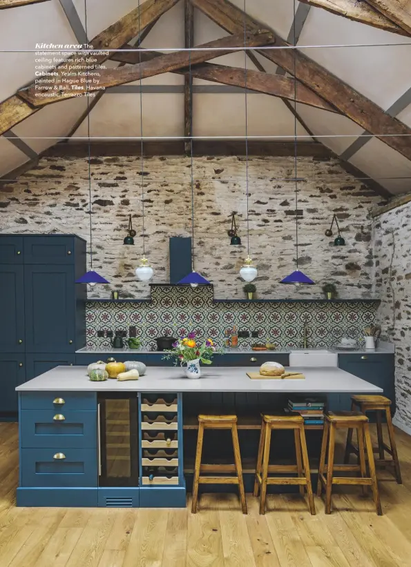  ??  ?? Kitchen area The statement space with vaulted ceiling features rich blue cabinets and patterned tiles.
Cabinets, Yealm Kitchens, painted in Hague Blue by Farrow & Ball. Tiles, Havana encaustic, Terrazzo Tiles