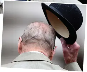  ??  ?? Last hurrah: Philip meets Marines at yesterday’s parade. Right: Tipping his bowler, he reveals his hearing aids