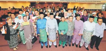  ??  ?? Awang Tengah (sixth right) with other guests of honour and recipients of aid at the event yesterday.