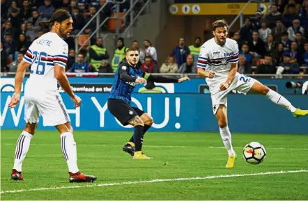  ??  ?? Mauro Icardi (centre) scoring Inter Milan’s second goal against Sampdoria in the Serie A match at the San Siro on Tuesday. —Reuters It’s going in: