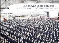  ??  ?? New employees of Japan Airlines Group attend an entrance ceremony at a hangar in Tokyo’s Haneda Airport on April 1, 1,460 new employees
of JAL Group attended the ceremony.