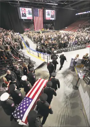  ?? George Frey / Getty Images ?? An honor guard brings the casket of Battalion Chief Matthew David Burchett into the Maverik Center for his funeral on Monday in West Valley City, Utah. Burchett was killed on Aug. 13 as he was fighting the Mendocino Complex Fire in Northern California, the largest fire in California history. Burchett was one of several Utah firefighte­rs who were sent to California to help out with several large fires. Burchett is survived by his wife and a 7-year-old son.