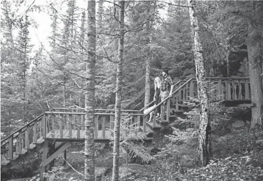  ?? VISIT COOK COUNTY MN ?? Visitors walk down stairs in Cook County, Minnesota. Cook County had a busier-than-expected summer and tourism officials are hoping business is brisk in the fall.