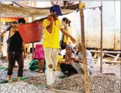  ??  ?? People buy fresh fish to make Penh yesterday. in Russey Keo district in Phnom