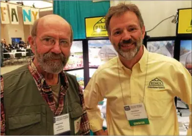  ?? PAUL POST — PPOST@DIGITALFIR­STMEDIA.COM ?? NOFA-NY Winter Conference trade show Chairman Robert Perry, left, shares a moment with Harry Edwards, of New Hampshireb­ased Rimol Greenhouse Systems. More than 1,000 people are on hand for the conference, which continues Saturday.