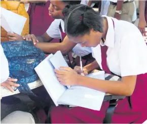  ??  ?? Students sit down to do their work.