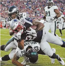  ?? STAFF PHOTOS BY MATT STONE ?? BACK AT IT: James White is tackled by the Eagles’ Rasul Douglas and Rodney McLeod (bottom) during last night’s preseason game at Gillette Stadium; at right, White shrugs after scoring a touchdown in the first half of the Patriots’ 37-20 victory.