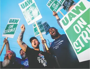  ?? Jake May / The Flint Journal via the asociat ed press files ?? GM employees protest outside of the Flint Assembly Plant last week when thousands of members of the United Auto Workers walked off factory floors or set up picket lines.