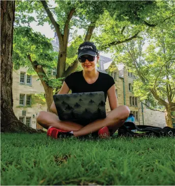  ?? Flickr photo Michael Swan ?? A student working outdoors at the University of St. Michael’s College, Toronto.