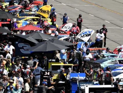  ?? Logan Riely, Getty Images ?? Crews work on cars during practice for the NASCAR Cup Series M& M's Fan Appreciati­on 400 at Pocono Raceway on Saturday in Long Pond, Pa.