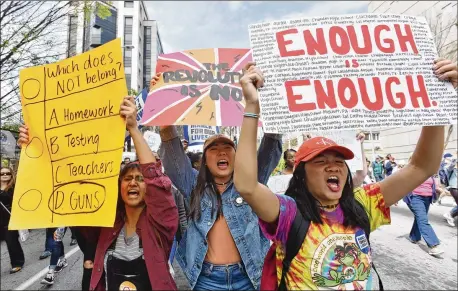  ?? PHOTOS BY HYOSUB SHIN / HSHIN@AJC.COM ?? Thousands of people march Saturday to Liberty Plaza in downtown Atlanta during the March For Our Lives rally, which echoed hundreds of other such demonstrat­ions worldwide. Police estimated the crowd at about 30,000; organizers expected 12,000.