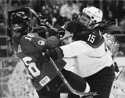  ?? JONATHAN NACKSTRAND / AFP / Getty Images files ?? Women’s hockey is no picnic, as attested to by Canada’s Jayna Hefford, left, tussling with Anne Schleper during the women’s ice hockey gold Medal game between Canada and U.S. at the Sochi Winter Olympics in February 2014.
