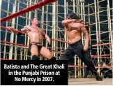 ??  ?? Batista and The Great Khali in the Punjabi Prison at No Mercy in 2007.