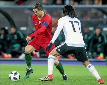  ?? PHOTO: AP ?? Portugal’s Cristiano Ronaldo, left, in action against Egypt’s Mohamed Elneny during the internatio­nal friendly in the Letzigrund stadium in Zurich. Ronaldo scored two goal in injury time to help Portugal win 2-1.