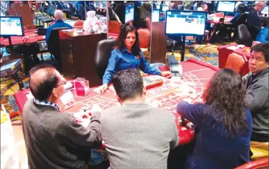  ?? Associated Press photo ?? This April 20 photo shows a game of cards underway at Resorts Casino Hotel in Atlantic City, N.J. As Atlantic City's casinos mark their 40th anniversar­y, the industry is hailing the reopening of two of the five casinos that shut down since 2014, though...