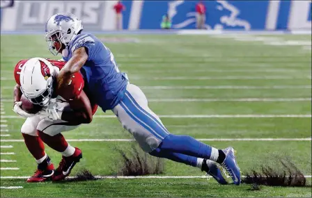  ?? ASSOCIATED PRESS ?? DETROIT LIONS FREE SAFETY GLOVER QUIN (RIGHT) tackles Arizona Cardinals running back David Johnson (31) during the first half of Sunday’s game in Detroit.