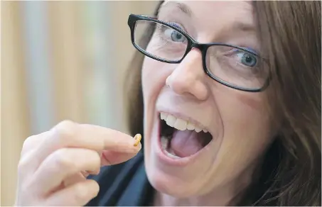  ??  ?? Swan Lake Christmas Hill Sanctuary executive director Kathleen Burton eats a mealworm in exchange for a $500 donation to the sanctuary.