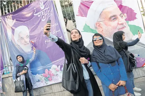  ?? EPA ?? Supporters of Hassan Rouhani pose for selfies during an election rally in Tehran on Tuesday. Mr Rouhani will vie for a second term as president in upcoming elections.