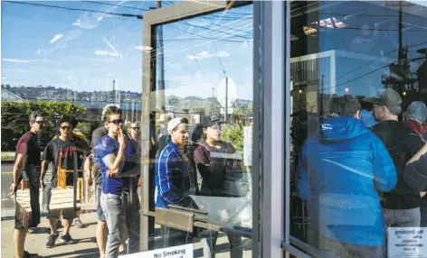  ?? Photos by Jessica Christian / The Chronicle ?? Dozens line up outside Fieldwork Brewing Co. in Berkeley for three specialty beers during a special can release Saturday.