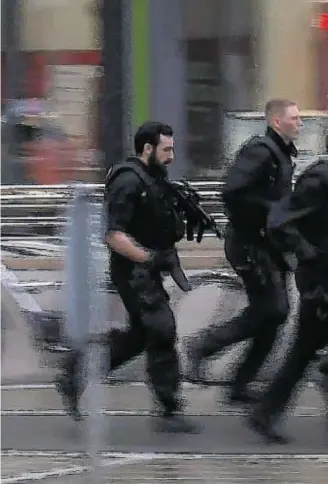  ??  ?? FAST REACTION: In this grab taken from video, police run in the area of the Olympia