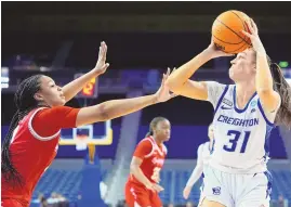  ?? ASSOCIATED PRESS ?? Creighton forward Emma Ronsiek, right, shoots over UNLV forward Alyssa Brown during Saturday’s NCAA Tournament game in Los Angeles.