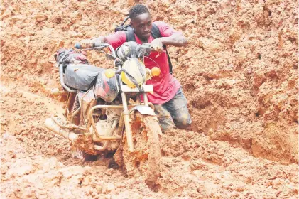  ?? Picture: EPA-EFE ?? A man battles through mud due to heavy rainfall on a highway of Sinoe County, Liberia.