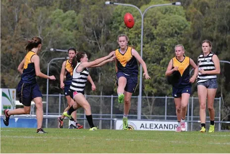  ?? Photo: Fairholme College ?? PROGRESSIN­G THROUGH: Claudia Ott kicks forward for Fairholme College. The school is now in the final four of the senior females division in AFLQ School football.