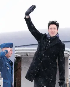  ?? PAUL CHIASSON / THE CANADIAN PRESS ?? Prime Minister Justin Trudeau waves from the steps of his plane as he departs Ottawa for Davos on Monday.