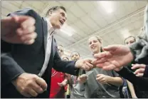  ?? MARIO TAMA/ GETTY IMAGES ?? Republican presidenti­al candidate Mitt Romney shakes hands with students during a campaign rally at Taylor- Winfield Technologi­es on Monday in Youngstown, Ohio.