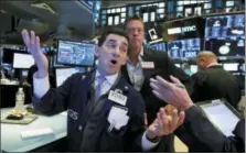  ?? RICHARD DREW — THE ASSOCIATED PRESS ?? Specialist Peter Mazza, left, works Wednesday on the floor of the New York Stock Exchange.