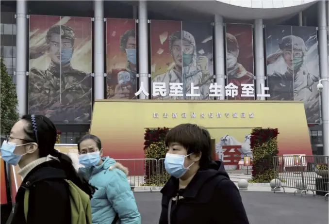  ?? Koki Kataoka / The Yomiuri Shimbun ?? The Wuhan Keting-Chinese Culture Expo Center in Wuhan, the capital of China’s Hubei Province, has been showing a special exhibition on China’s fight against the COVID-19 epidemic. In this photo taken on Dec. 1, a sign is seen with a slogan meaning “Put people and life first.”