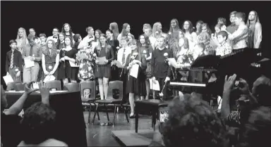  ?? Westside Eagle Observer/SUSAN HOLLAND ?? The 42 newly inducted members of the National Junior Honor Society stand on the stage following their induction ceremony. The induction was held Feb. 26 at the Gravette High School Performing Arts Center. A reception was held following the ceremony.